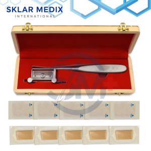 Silver dermatome skin graft knife with grooved roller bar, adjustable thickness control, 19 cm length, and wooden storage box including 10 sterile blades for skin grafting procedures.