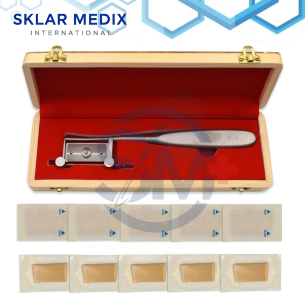 Silver dermatome skin graft knife with grooved roller bar, adjustable thickness control, 19 cm length, and wooden storage box including 10 sterile blades for skin grafting procedures.